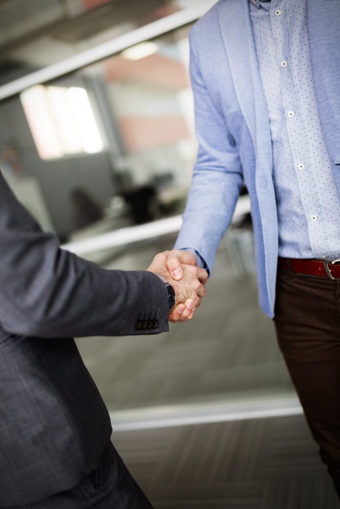 Business people shaking hands, finishing up meeting