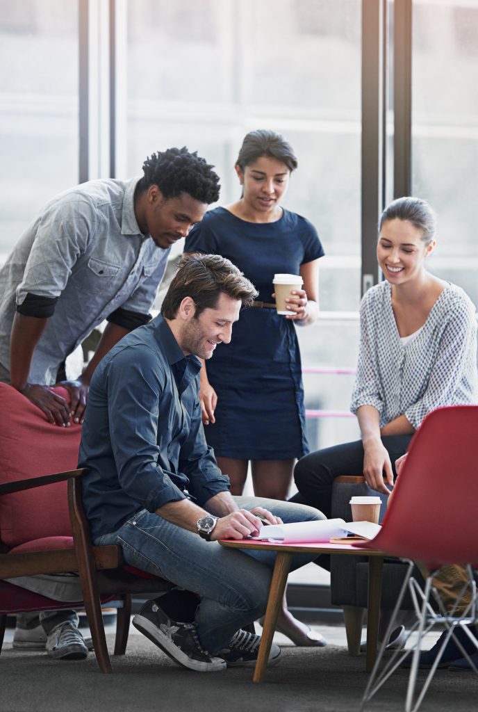 Getting the team motivated. Shot of a group of coworkers in a meeting in an office.